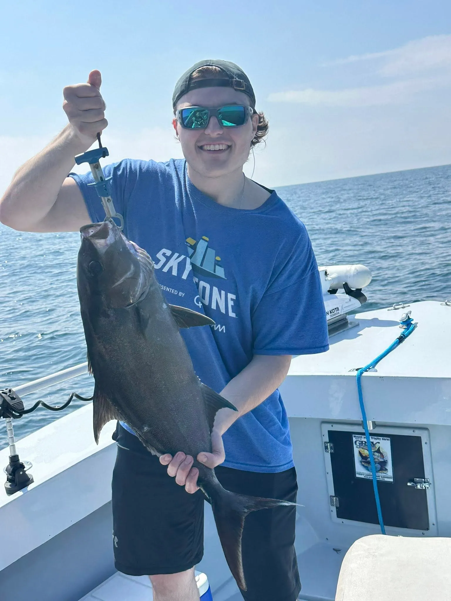 Charter boat offshore with anglers and a fresh catch near Pensacola